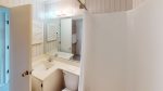 Bathroom with single sink basin, tub/shower combination